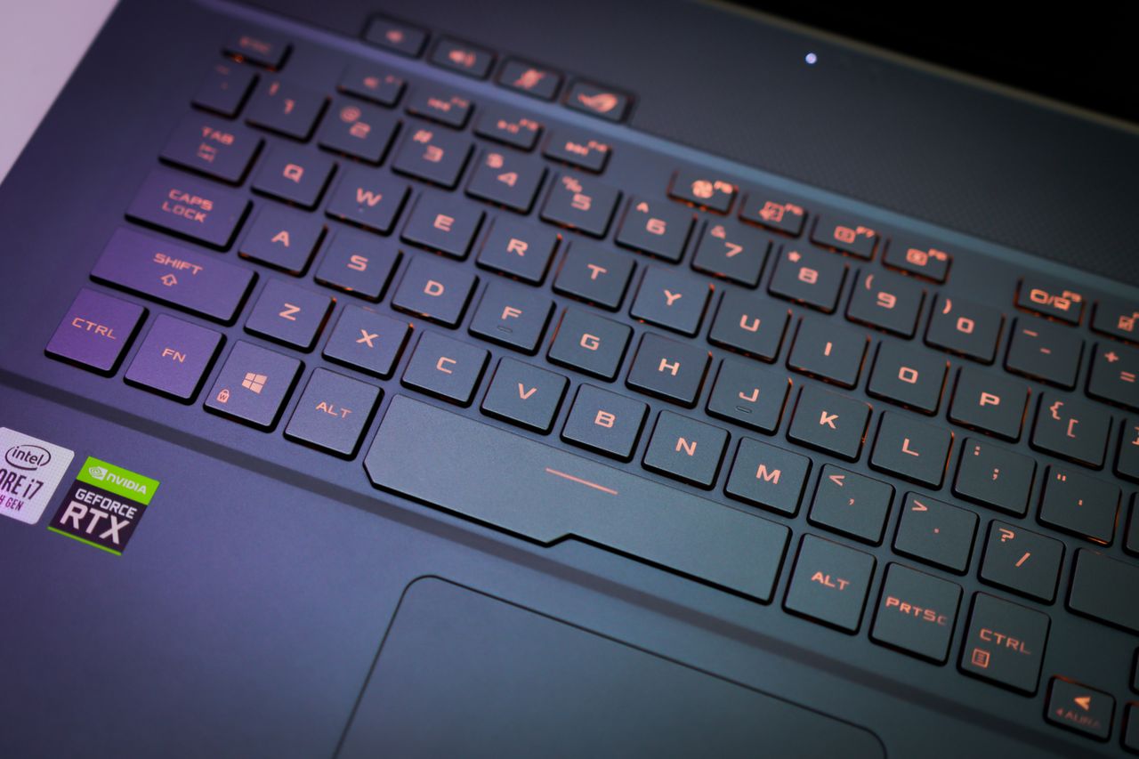 A close-up image of a laptop keyboard with illuminated keys, showcasing a modern design.